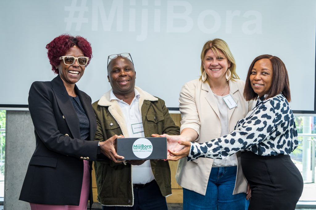 Municipal representatives holding a gift box labelled 'MijiBora'.